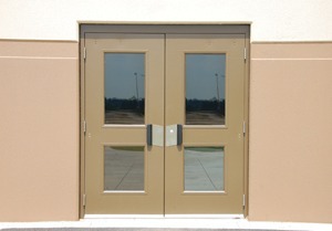 photo of tan exterior double steel doors with four panes
